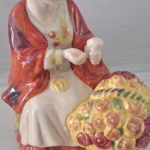Royal Doulton Ceramic Figurine with Red and Yellow Accents